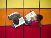 Alexander Lorenzo, left, 9, reads "The Gym Teacher from the Black Lagoon" to Christopher Lopez, 9, in Jennifer Crosby's third grade class at Woodland Intermediate School on Tuesday, October 25, 2016. Crosby and fellow third grade teacher, Megan Lascik, are giving students flexible seating options in class to help them learn more comfortably.