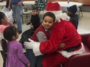 Evergreen Highlands: Bonneville Power Administration employees brought gifts and Santa to a visit at the Learning Avenues Child Care Center on Dec.