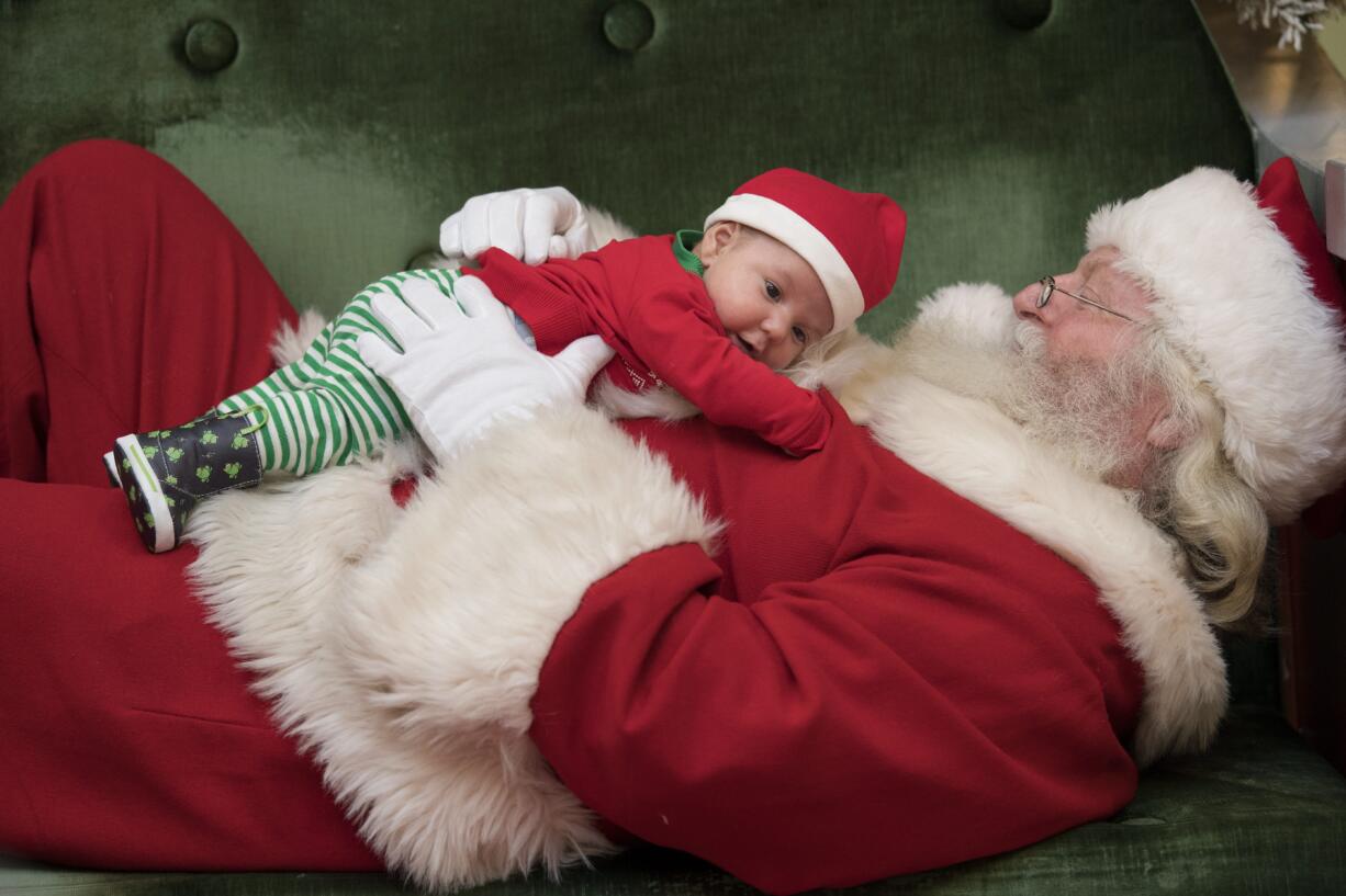 Sawyer Shoemaker, 7 weeks, of California, cuddles up with Santa while having a photo taken at Vancouver Mall while joined by his mom, Zandra, not pictured, Wednesday afternoon, Dec. 21, 2016. The mom and baby were in Vancouver to celebrate his first Christmas with family. Santa is available at the mall from 10 a.m. to 9 p.m. through Dec. 23 and from 9 a.m. to 6 p.m. on Dec.