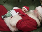 Sawyer Shoemaker, 7 weeks, of California, cuddles up with Santa while having a photo taken at Vancouver Mall while joined by his mom, Zandra, not pictured, Wednesday afternoon, Dec. 21, 2016. The mom and baby were in Vancouver to celebrate his first Christmas with family. Santa is available at the mall from 10 a.m. to 9 p.m. through Dec. 23 and from 9 a.m. to 6 p.m. on Dec.