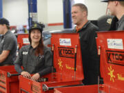 Evelyn Nagornyy, a first-year student in Clark College&#039;s automotive technology program, left, talks to Tom Gilstrap, center, a service manager at Dick Hannah Subaru, during a small ceremony at Clark College where automotive technology students received toolboxes from the Dick Hannah Dealerships in Vancouver.