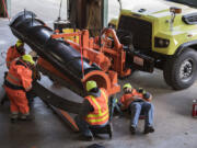 Washington State Department of Transportation crews help prepare a snowplow for upcoming winter conditions Wednesday afternoon at their Vancouver maintenance facility.