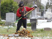 John Lynch of Black Diamond cleaned and decorated the Old City Cemetery on Saturday. Lynch, also known as &quot;Bottle Hound,&quot; is a member of The Ancient and Honorable Order of E Clampus Vitus.