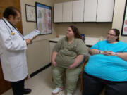 Identical twins Brandi, left, and Kandi Dreier of Vancouver meet with Dr.