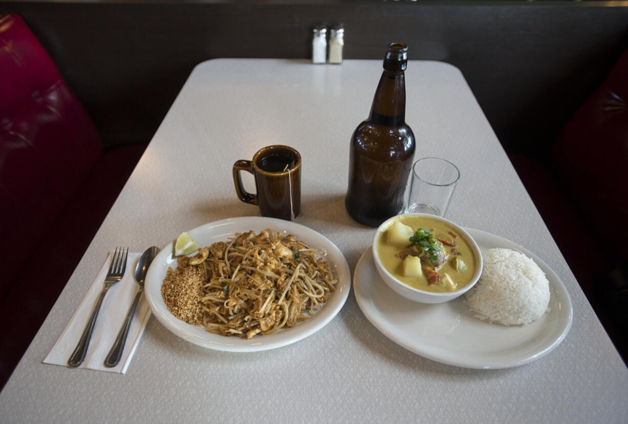 Pad thai with chicken, left, and chicken yellow curry are served Dec. 12 at Ginger Pop in Vancouver.