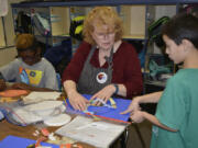 Washougal: Gause Elementary School&#039;s Peggy Ross works with students in art class while they create new animals as part of new curriculum to learn different animal classifications.