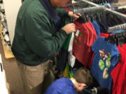 Vancouver Mall: Rotary member Wayne Clemetson helps a child shop at J.C.