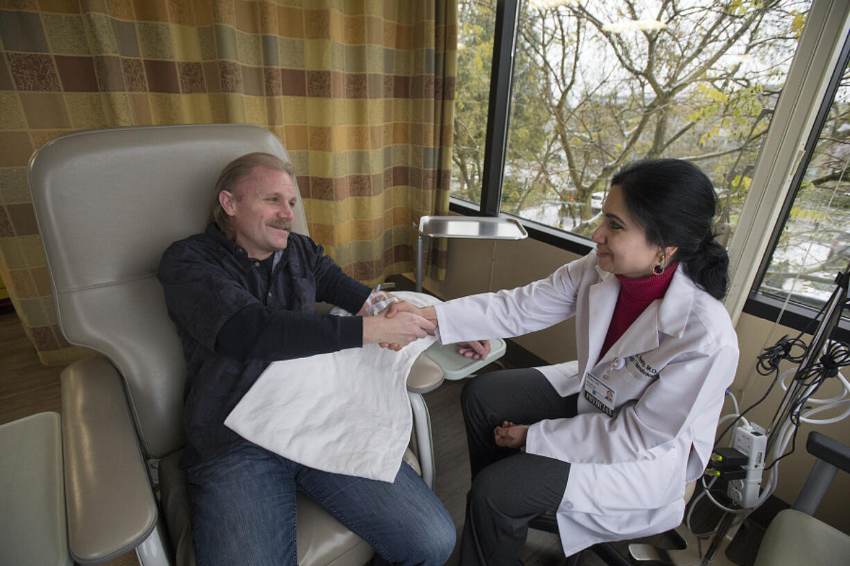 Lane Mimnaugh of Vancouver, left, thanks Dr. Aruna Reddy before receiving a dose of the immunotherapy drug, Keytruda,  earlier this month at PeaceHealth Southwest Medical Center. Mimnaugh is the first patient at PeaceHealth Southwest to undergo treatment with the drug and has responded well.