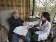 Lane Mimnaugh of Vancouver, left, thanks Dr. Aruna Reddy before receiving a dose of the immunotherapy drug, Keytruda,  earlier this month at PeaceHealth Southwest Medical Center. Mimnaugh is the first patient at PeaceHealth Southwest to undergo treatment with the drug and has responded well.