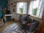 Yung Ting Engelbrecht enjoys a show on his tablet while relaxing at his east Vancouver home, an accessory dwelling unit that’s attached to his parents’ house.