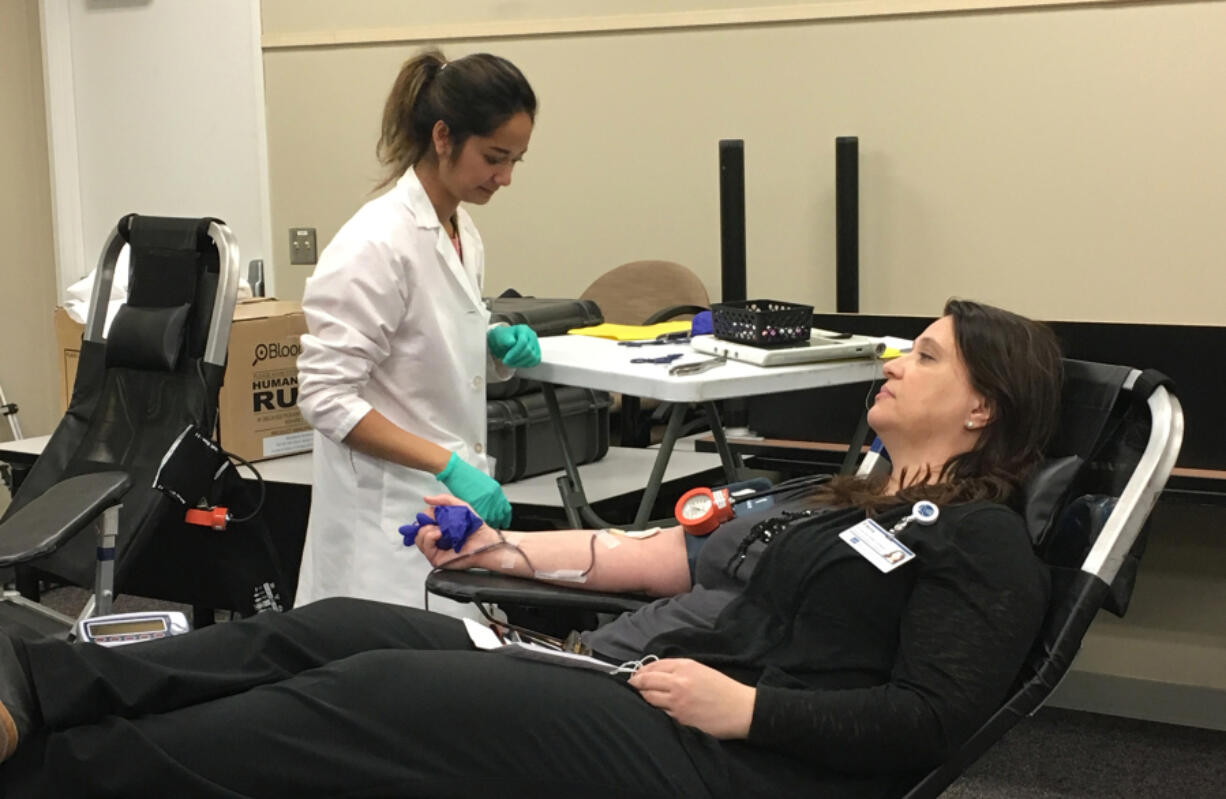 Vancouver Mall: Bloodworks Northwest&#039;s Vanny Chao, left, works with Elena Bauer during a blood drive at HP Inc.&#039;s Vancouver location.