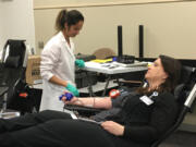 Vancouver Mall: Bloodworks Northwest&#039;s Vanny Chao, left, works with Elena Bauer during a blood drive at HP Inc.&#039;s Vancouver location.