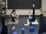 Aderyn McLean, 11, of Vancouver, left, joins her mom, Kelly McLean, teaching yoga at a studio in Camas. McLean said she hopes to pursue careers in writing and teaching.