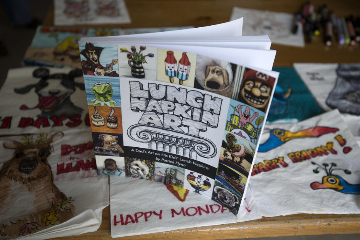 The book "Lunch Napkin Art" features the work of artist Patrick Flynn, as seen at his Salmon Creek-area home earlier this month.