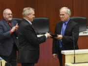 County Councilor David Madore accepts a plaque Tuesday from County Chair Marc Boldt acknowledging his work on the council at the last Clark County council hearing to include Madore and Councilor Tom Mielke on Tuesday.