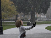 Delainey Poe of Vancouver catches snowflakes on her tongue in 2016 at Esther Short Park.