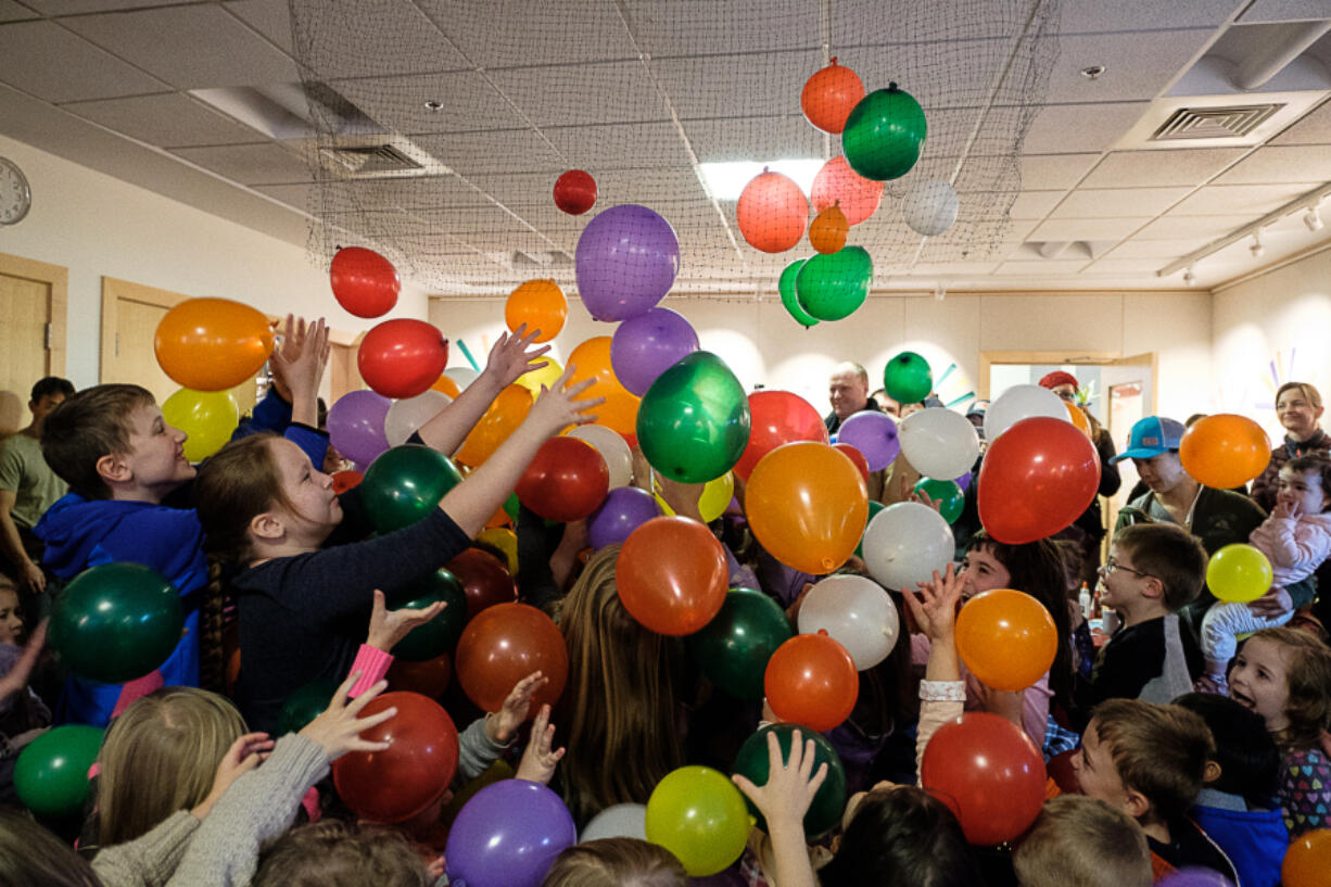 Balloons drop on children who had counted down to noon Saturday at the Noon Year&#039;s Celebration at the Three Creeks Community Library in Salmon Creek.