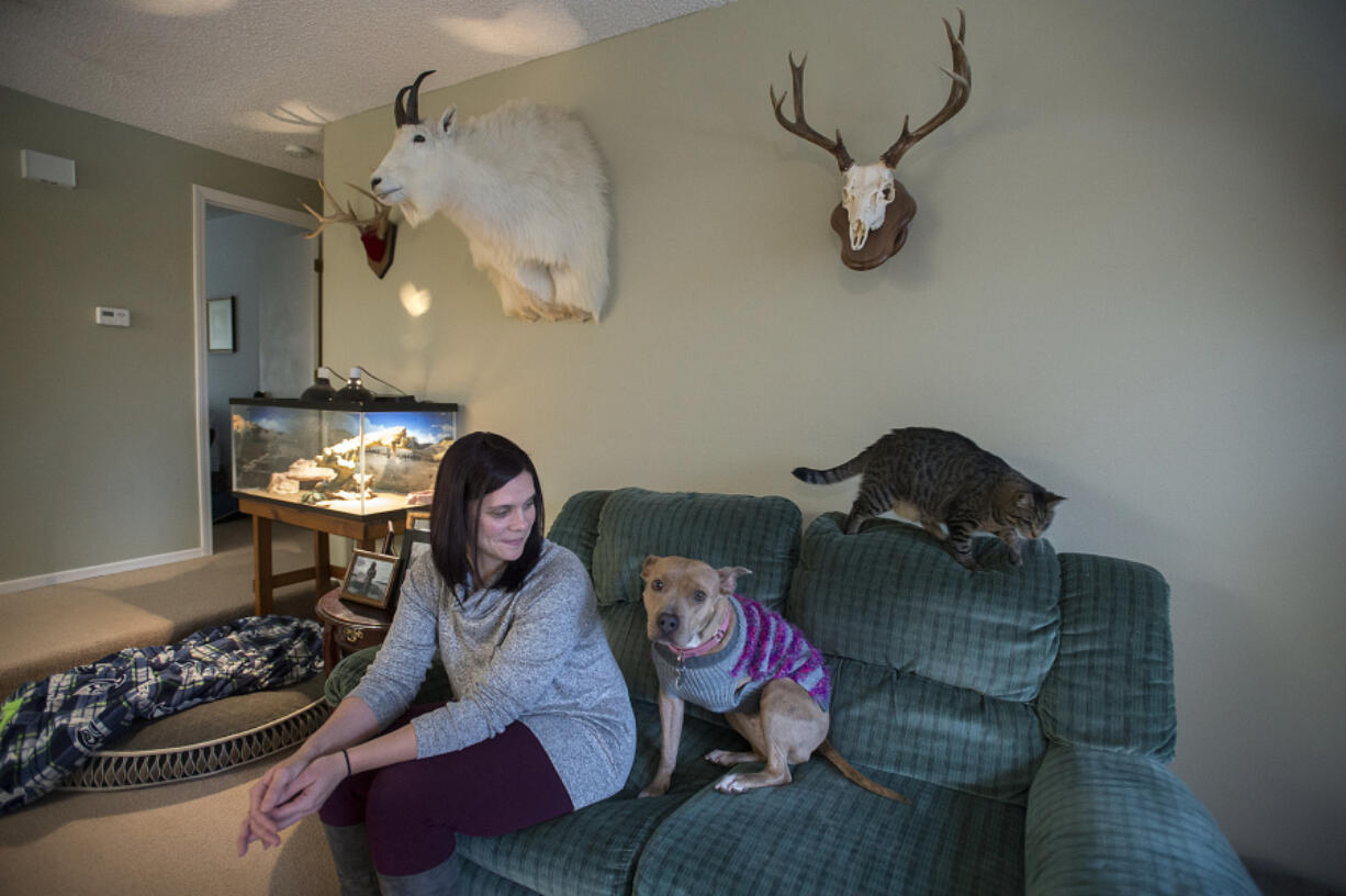 Heather Matson shares a moment with Jenny, her three-legged pit bull, who recently won the title of Portland&#039;s Next TopDog Model, while joined by kitty Maya on Dec. 19 at their Vancouver home. Matson adopted Jenny from a pit bull rescue in April 2015.