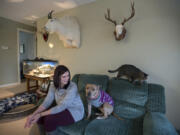 Heather Matson shares a moment with Jenny, her three-legged pit bull, who recently won the title of Portland&#039;s Next TopDog Model, while joined by kitty Maya on Dec. 19 at their Vancouver home. Matson adopted Jenny from a pit bull rescue in April 2015.