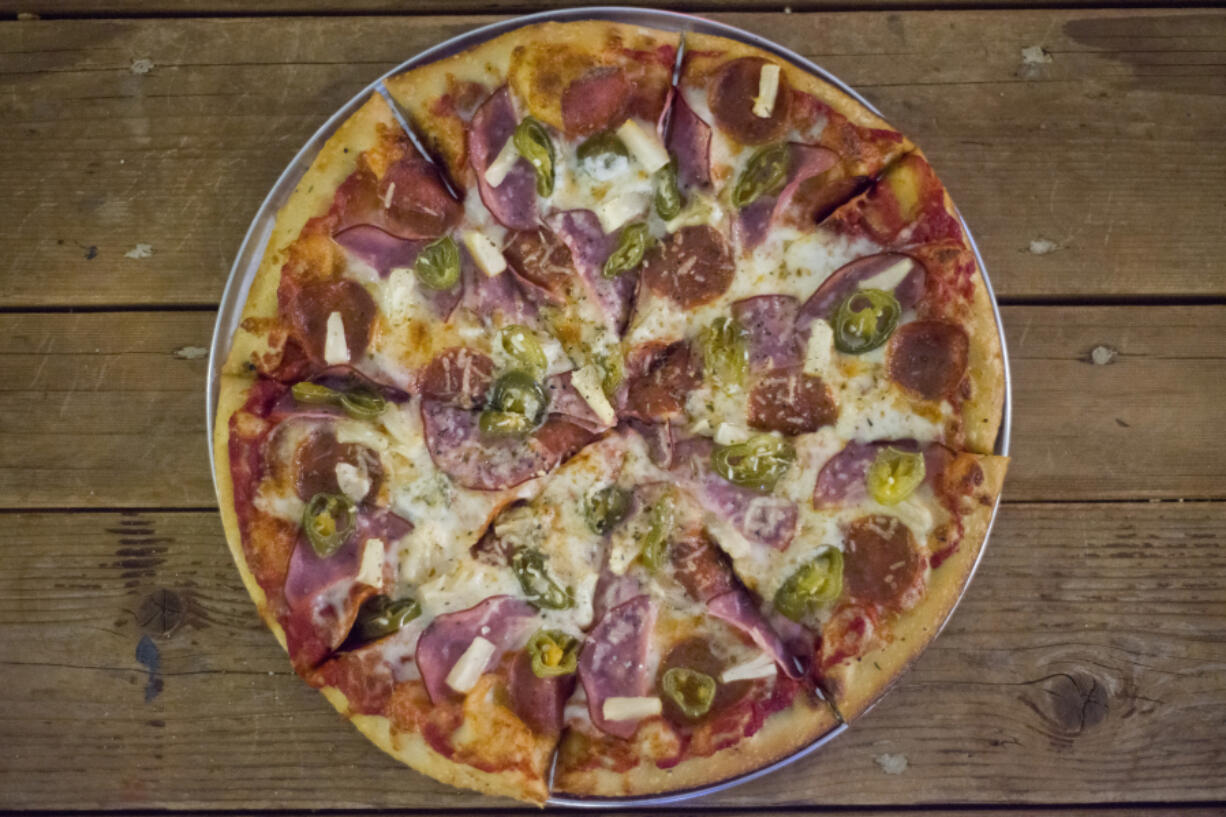 The Armageddon pizza is served Dec. 16 at Doomsday Brewing Co. in Washougal. It is topped with pepperoni, Canadian bacon, pineapple and jalapenos.