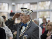 Pearl Harbor survivor Ralph Laedtke honors the flag Wednesday as the colors are posted during a remembrance marking the 75th anniversary of the attack on Dec. 7, 1941.