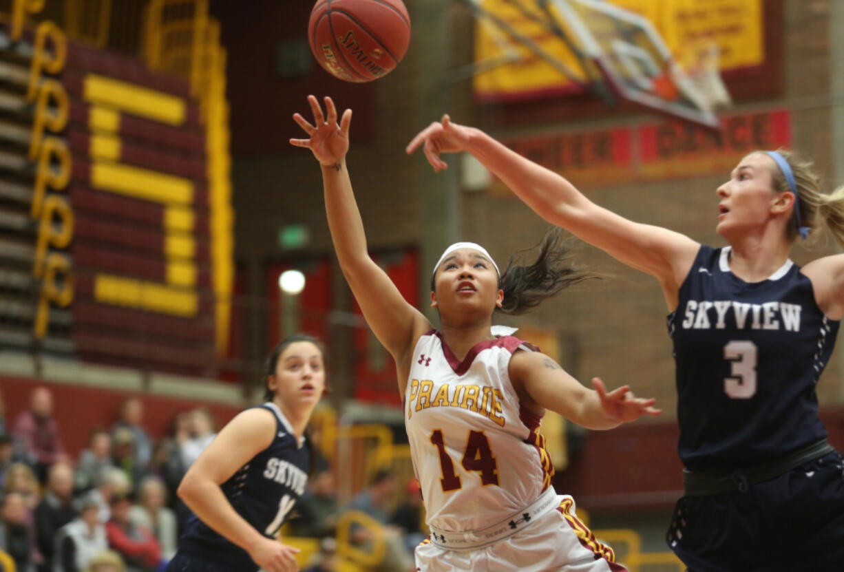 Grace Prom (14) of Prairie shoots the ball as Skyview's Riley Friauf tries to block the shot at a basketball game in Vancouver Tuesday December 13, 2016.