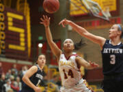 Grace Prom (14) of Prairie shoots the ball as Skyview's Riley Friauf tries to block the shot at a basketball game in Vancouver Tuesday December 13, 2016.