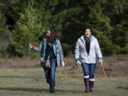 Ledella Lee, left, and Kim Castillo walk with a Christmas tree they cut in the Gifford Pinchot National Forest near Carson on Saturday.