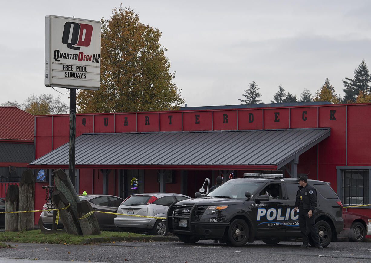 Police work at the scene of a shooting at QuarterDeck Bar on Thursday morning.