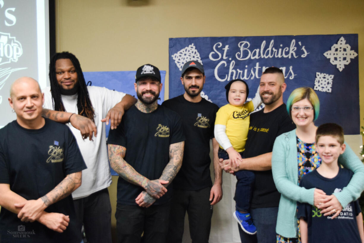 North Garrison Heights: Barbers from King&#039;s Barber Shop, from left, Juan Naranjo, Ryan Alexander, Ryan Wieser, and Mustafa Aljaf, with the Loomis family, from left, Halsten, Mike, Monica and Rennick Loomis. The barbers cut hair at a St.