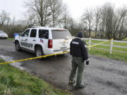 Clark County sheriff's Deputy Dan Perritt protects the perimeter around an officer-involved homicide investigation Sunday in the Ridgefield area. Police say a deputy shot and killed an armed man who allegedly trespassed on a homeowner&#039;s property Sunday morning.