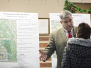 Clark College President Bob Knight speaks with a visitor Monday at the Ridgefield Community Center about plans for a new Clark College campus.