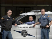 Trooper Shane Kesler, from left, joins his dad, retired Trooper Mike Kesler, and Shane&#039;s brother, Trooper Brandon Kesler, at the local Washington State Patrol office. The brothers followed in their father&#039;s footsteps and became troopers after their father retired in 2008.