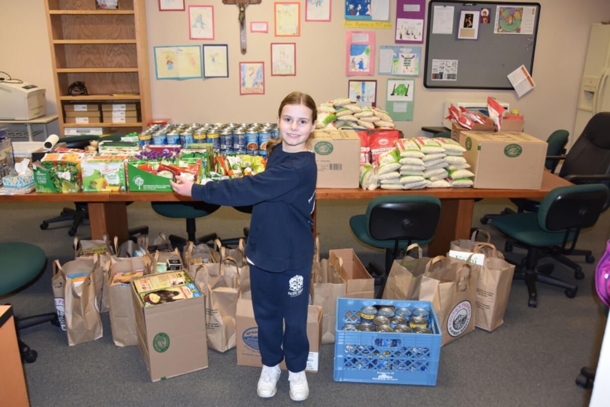 Camas: Pacific Crest Academy third-grader Katie Jackson, who collected more than 1,400 items for the school&#039;s food drive by going into Chuck&#039;s Produce and asking them for a donation.