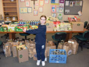 Camas: Pacific Crest Academy third-grader Katie Jackson, who collected more than 1,400 items for the school&#039;s food drive by going into Chuck&#039;s Produce and asking them for a donation.