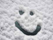 A friendly face is drawn into a snow-covered truck near Lincoln Elementary School on Dec. 15.