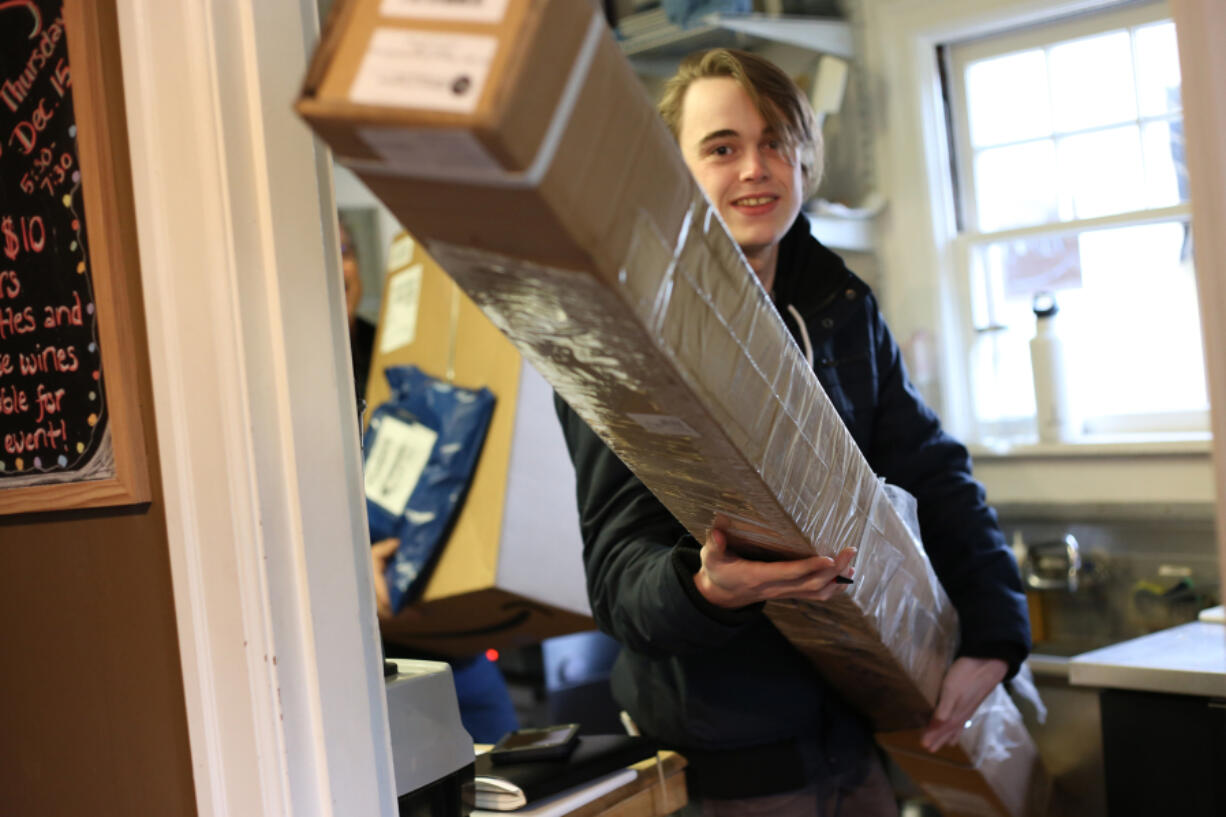 Latte Da Coffee House and Wine Bar, in the Lincoln neighborhood, can be sent holiday gifts to hold in order to curb theft and &quot;porch piracy.&quot; (Photos by Troy Brynelson/The Columbian)