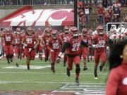 Washington State players run onto the field before an NCAA college football game against Washington, Friday, Nov. 25, 2016, in Pullman, Wash. (AP Photo/Ted S.