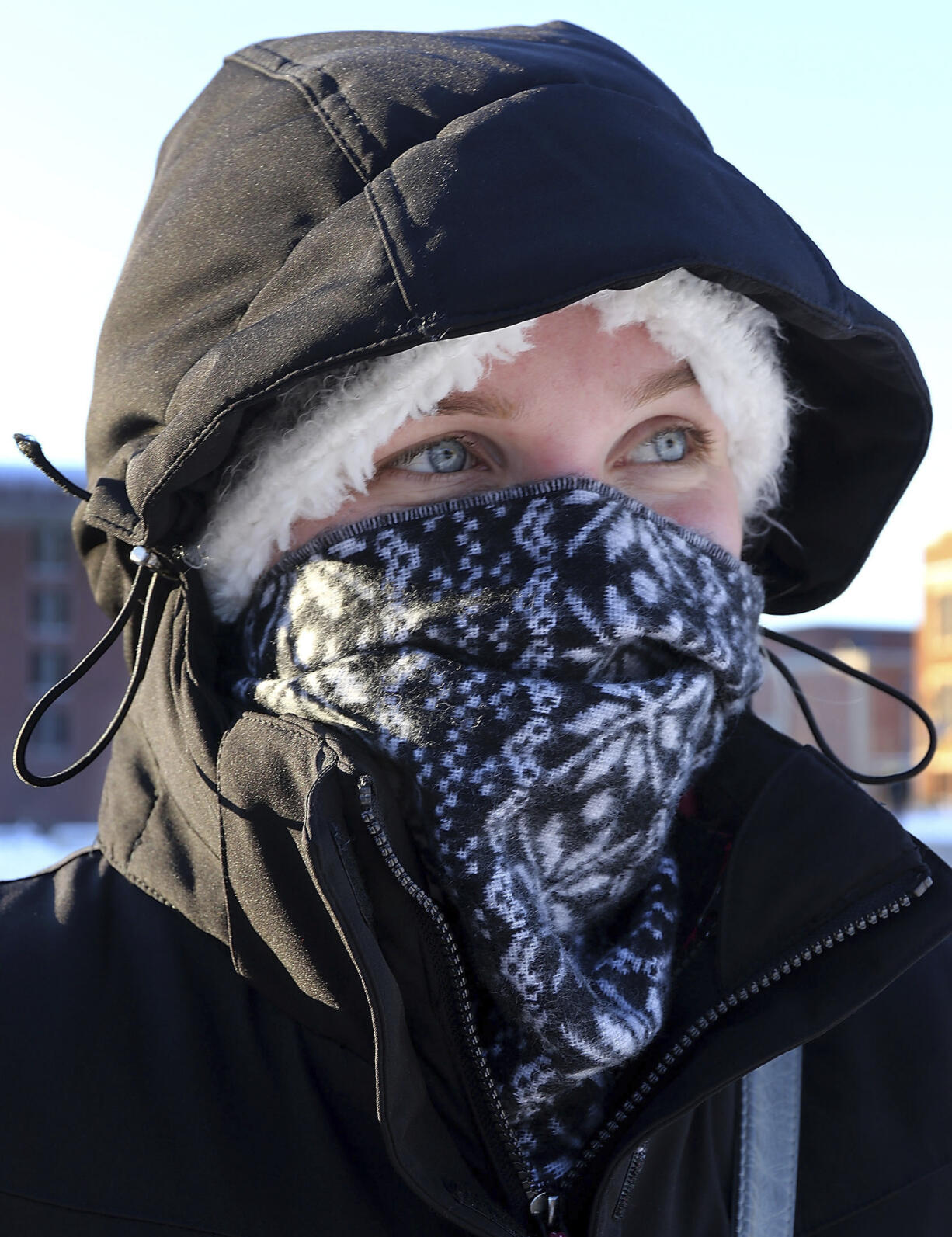 Bundled up for the cold, UW-Eau Claire freshman Rachel Blessinger, of Oak Creek, Wis., walks on campus in Eau Claire on Tuesday, Dec. 13, 2016.