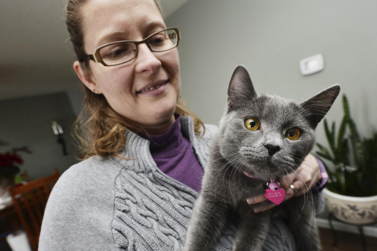 In this Tuesday, Dec. 13, 2016 photo, Robin Harris holds the cat, Cleo, in Mission, Ore., that she found in her hay barn over the weekend. The kitten ran off after her family was involved in a car crash near Harris's house while moving from Utah to Washington and was presumed dead until Harris called the family with the number on the cat's name tag. (E.J.