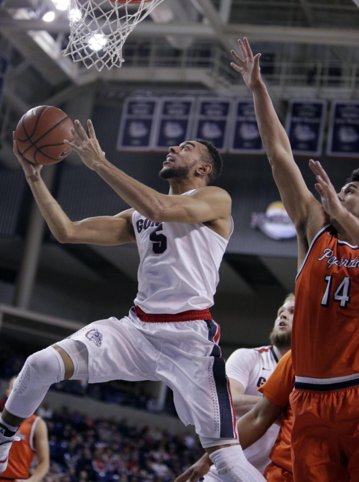 Gonzaga guard Nigel Williams-Goss (5) shoots while defended by Pepperdine forward Chris Reyes.