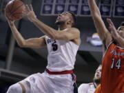 Gonzaga guard Nigel Williams-Goss (5) shoots while defended by Pepperdine forward Chris Reyes.