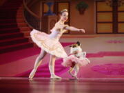 Performing as the Sugar Plum Fairy, Katherine Free, left, dances with Pig, the dog, Dec. 8 during the Birmingham&#039;s Ballet Mutt-cracker, a rendition of the famous ballet &quot;The Nutcracker,&quot; in Birmingham, Ala. Pig was a featured performer, wearing a pink tutu and dancing alone with the Sugar Plum Fairy in Act 2.