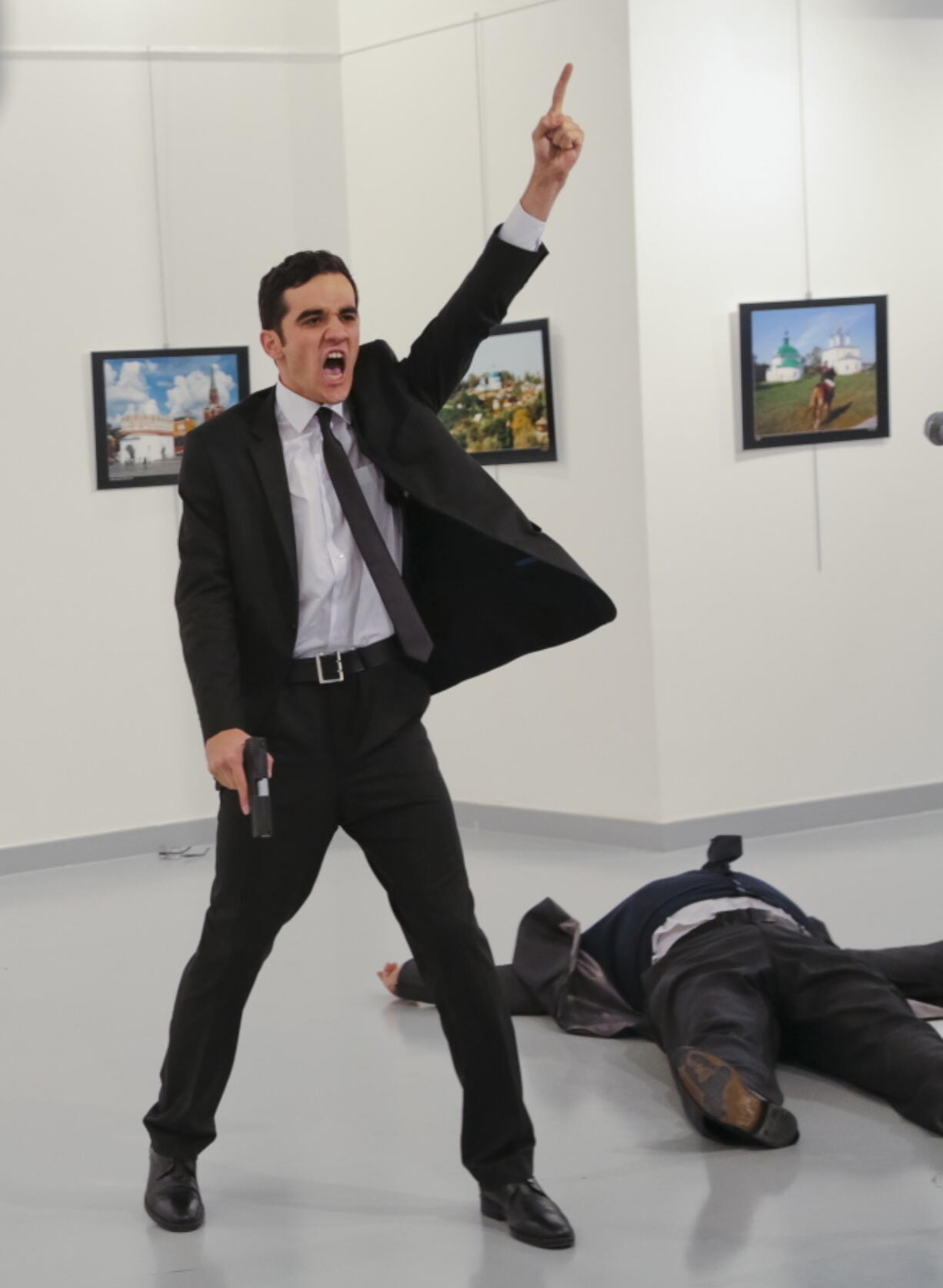 Mevlut Mert Altintas shouts Monday after shooting Russia&#039;s ambassador to Turkey, Andrei Karlov, at an art gallery in Ankara, Turkey. At first, AP photographer Burhan Ozbilici thought it was a theatrical stunt when the man in a dark suit and tie pulled out a gun during the exhibition.