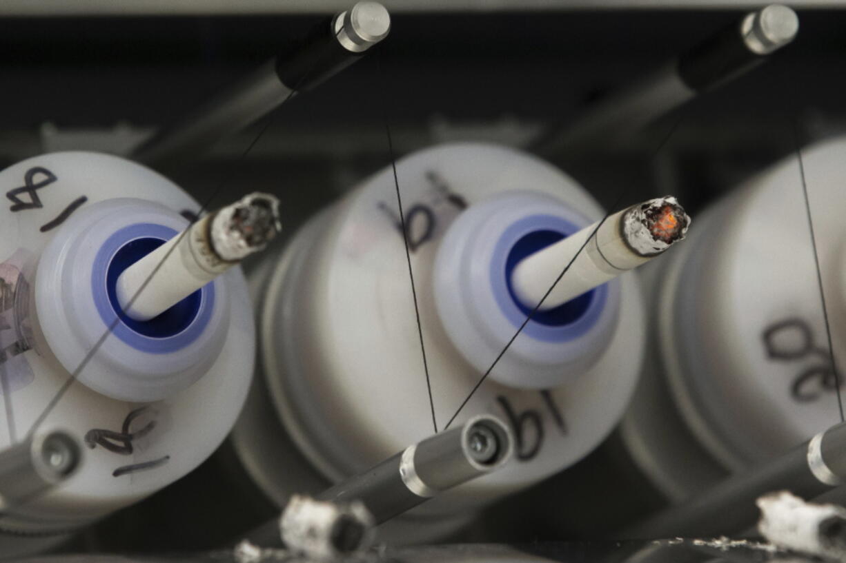 In this Thursday, Nov. 10, 2016 photo, test cigarettes burn in a smoking machine at the Centers for Disease Control and Prevention in Atlanta. On Monday, Dec. 5, 2016, the nation&#039;s top public health agency issued a frank assessment of its recent battles against prioritized health problems, finding progress in some areas but backslide in others. Despite the mixed grades in the CDCC?Us report card on itself, some experts applauded CDC efforts, saying the agency had only limited abilities to prevent illness or stop people from doing things that hurt their own health.