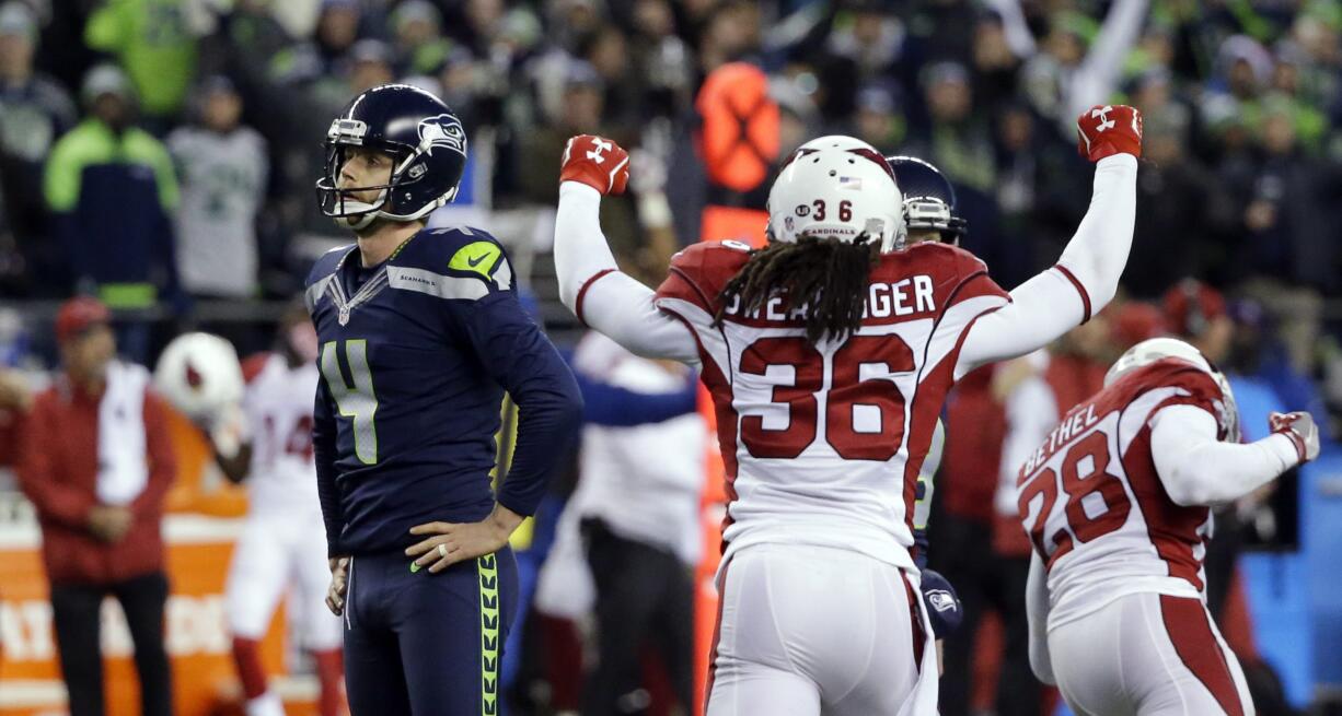 Seattle Seahawks kicker Steven Hauschka, left, and Arizona Cardinals free safety D.J. Swearinger (36) react after Hauschka missed a point after a touchdown in the fourth quarter of an NFL football game, Saturday, Dec. 24, 2016, in Seattle.  (AP Photo/Ted S.