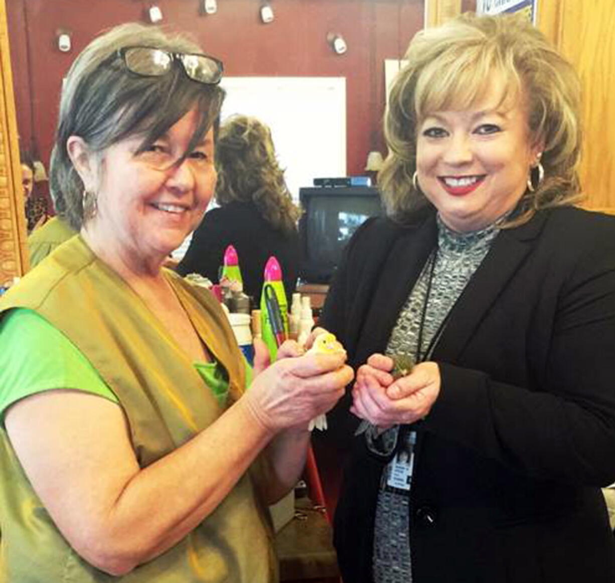 Rhonda King, of Grant, Ala., left, holds a canary Friday with USPS Operations Manager Sherry Hyche. King was crestfallen earlier in the month, when she received a half-dozen dead canaries in a package marked with tire tracks. The U.S. Postal Service said they later paid for seven new canaries plus the postage needed to send them to King.