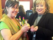 Rhonda King, of Grant, Ala., left, holds a canary Friday with USPS Operations Manager Sherry Hyche. King was crestfallen earlier in the month, when she received a half-dozen dead canaries in a package marked with tire tracks. The U.S. Postal Service said they later paid for seven new canaries plus the postage needed to send them to King.