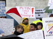 Protestors encourage electors to vote against Donald Trump and call for general electoral college reform outside the Oregon State Capitol in Salem, Ore., on Monday.