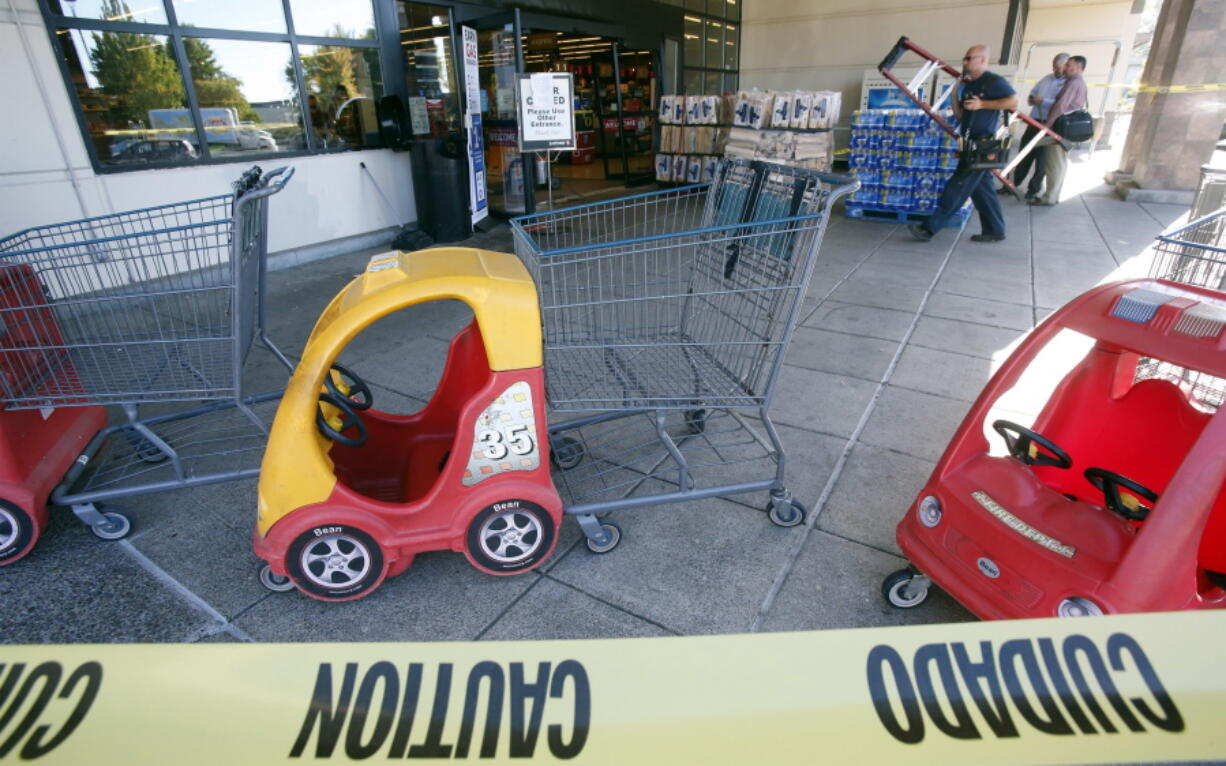 Safeway employee David White cleans near the damaged entrance to the grocery store in Eugene, Ore., on Aug. 24, 2016, after a woman drove her SUV into the store and down the aisles. A judge has found Noella Fay guilty and will decide next year whether to send her to a mental hospital.